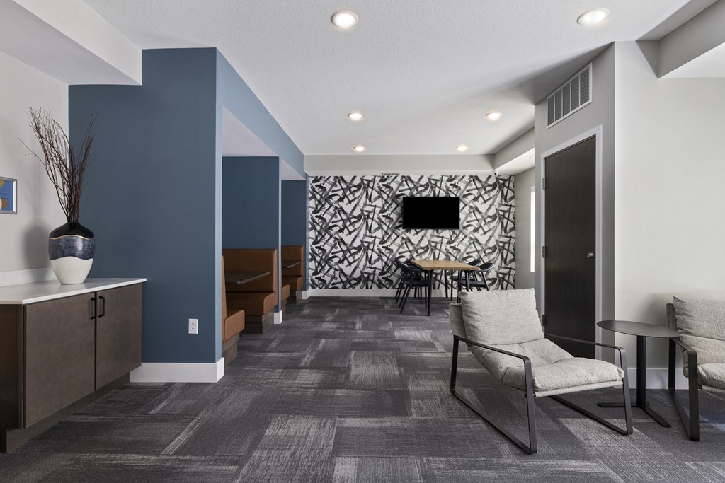 a living room with blue and white walls and a table and chairs