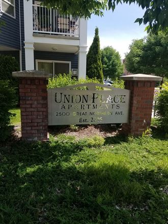a sign for union place apartments in front of a building