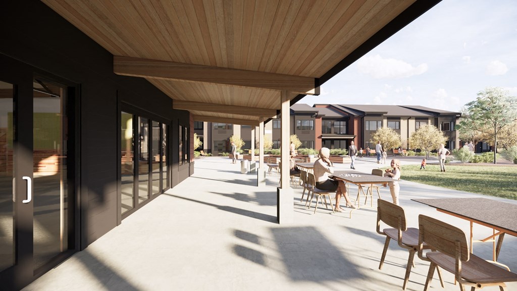 a patio with tables and chairs and buildings in the background