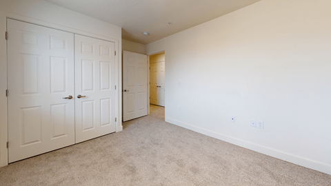 a bedroom with two closets and a door to a bathroom