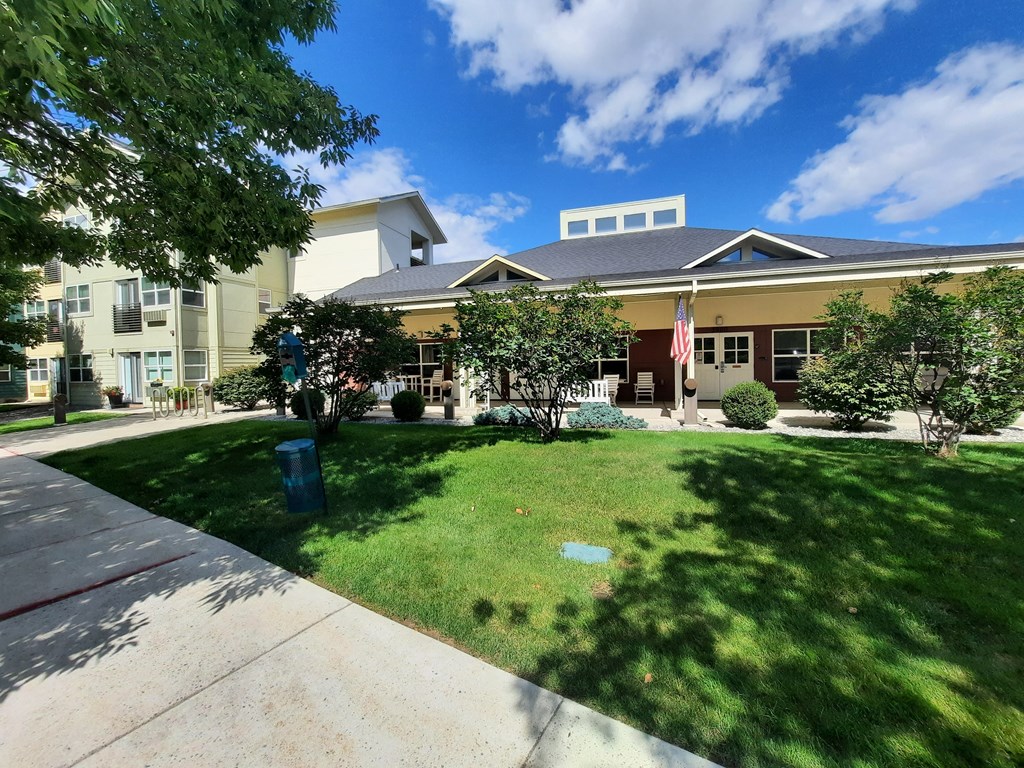 a large building with a lawn in front of it