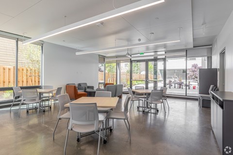A conference room with a long table and chairs.