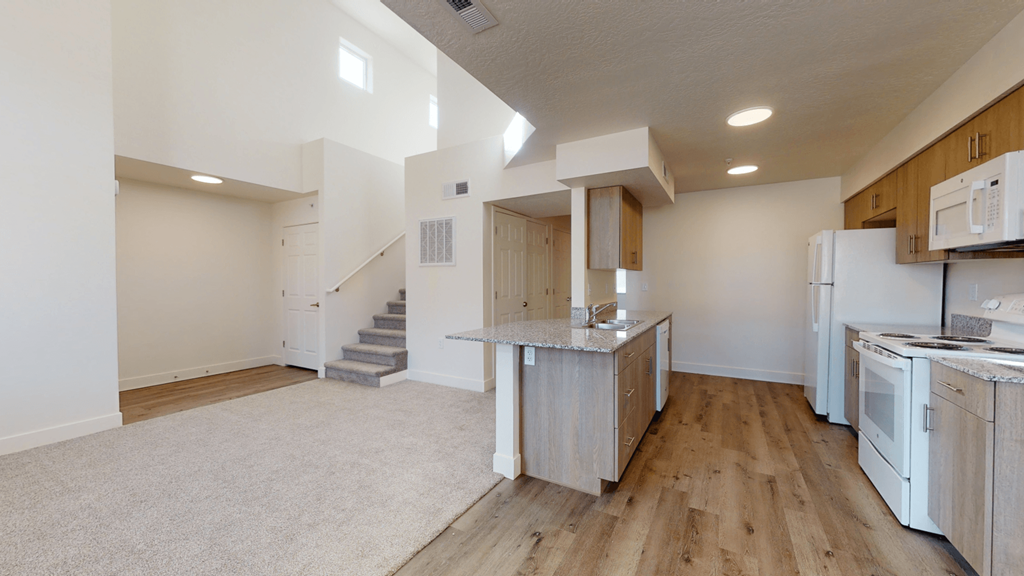 a kitchen with white appliances and a counter top in a house
