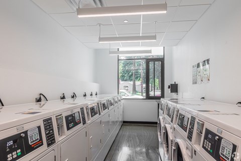 A row of washing machines in a laundromat.