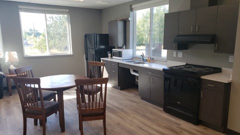 an open kitchen and dining room with a table and chairs