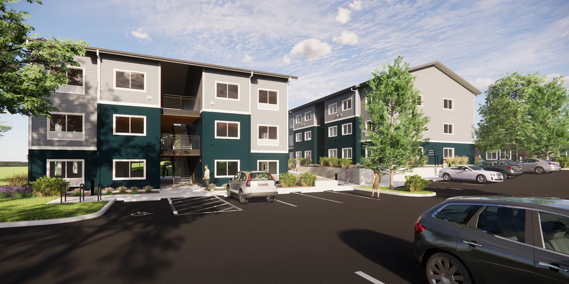 A modern apartment complex with a parking lot in front.