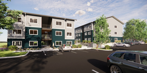 A modern apartment complex with a parking lot in front.