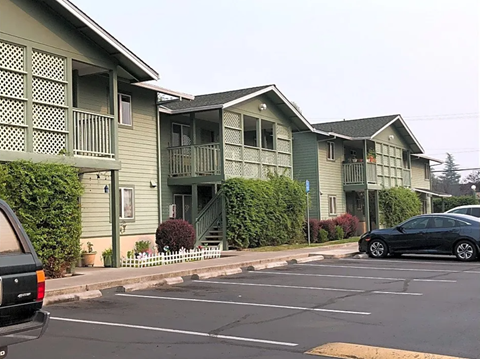 an empty parking lot in front of an apartment building