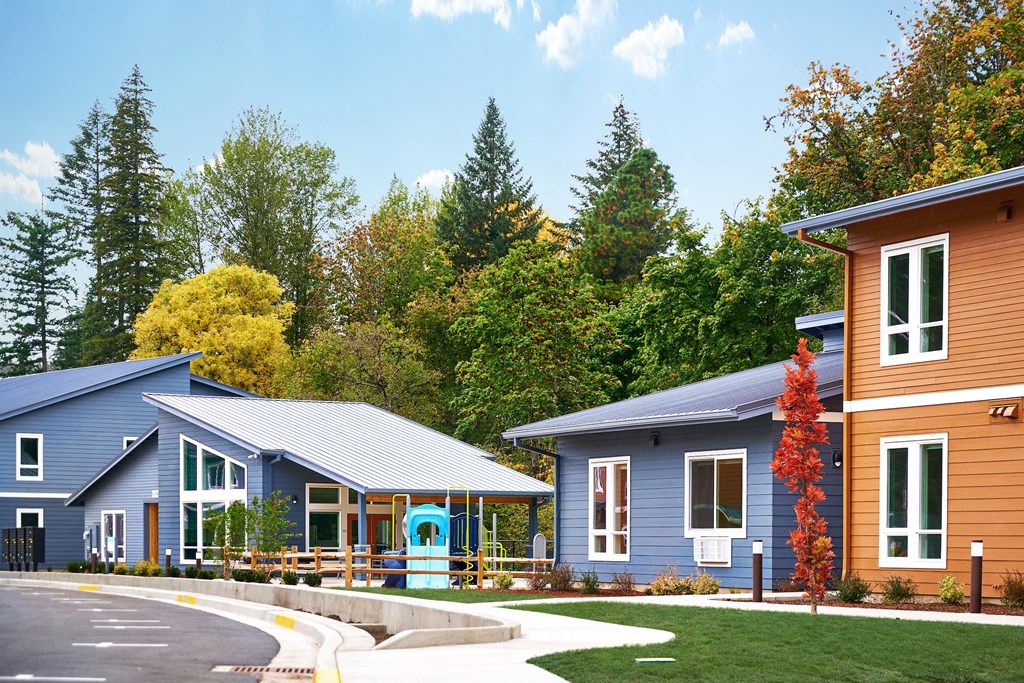 a row of houses with trees in the background