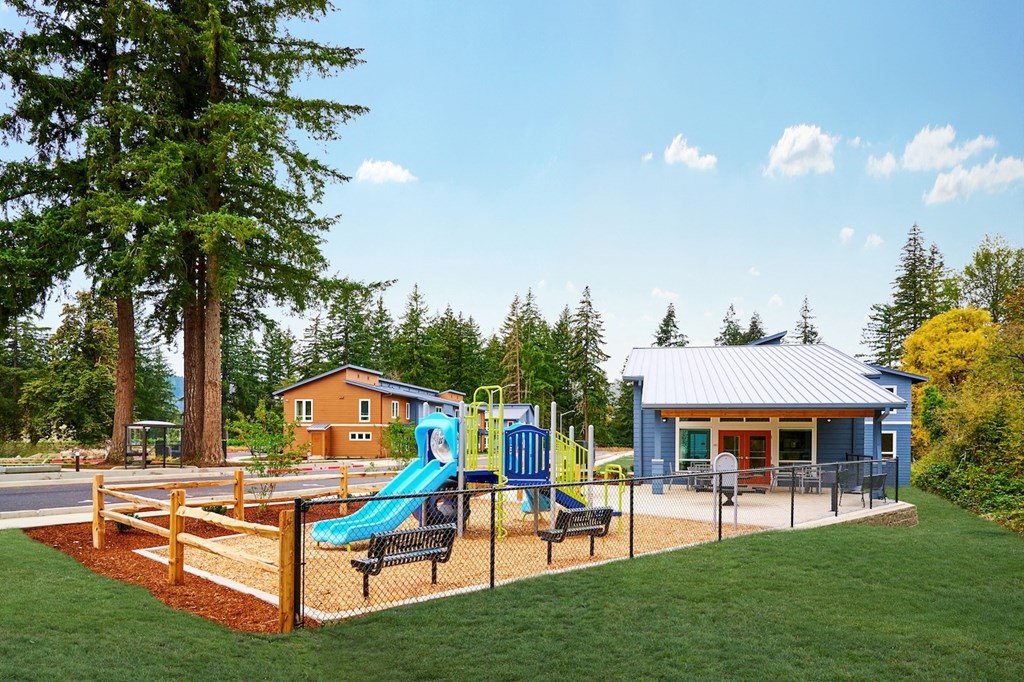 a playground with a swing set and a pavilion