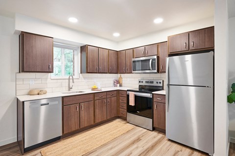 a kitchen with stainless steel appliances and wooden cabinets