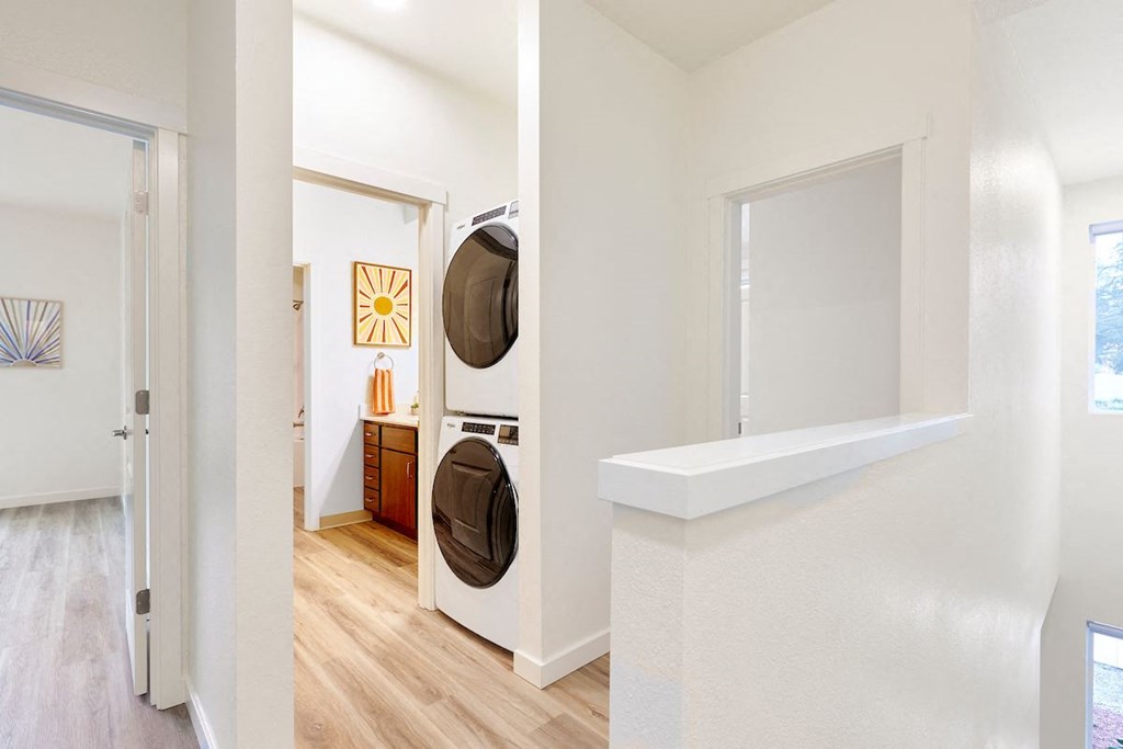 a living room with a washer and dryer in it