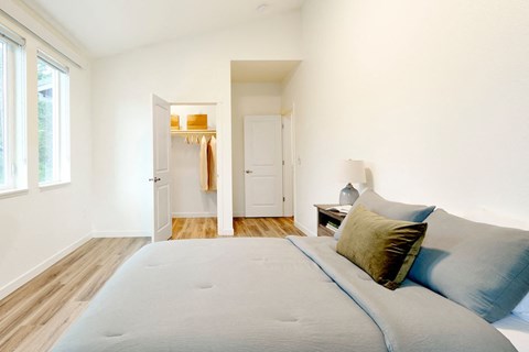 a bedroom with a large bed and a door to a closet