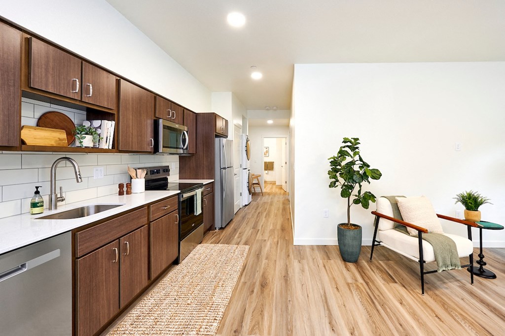 a kitchen with wooden cabinets and stainless steel appliances