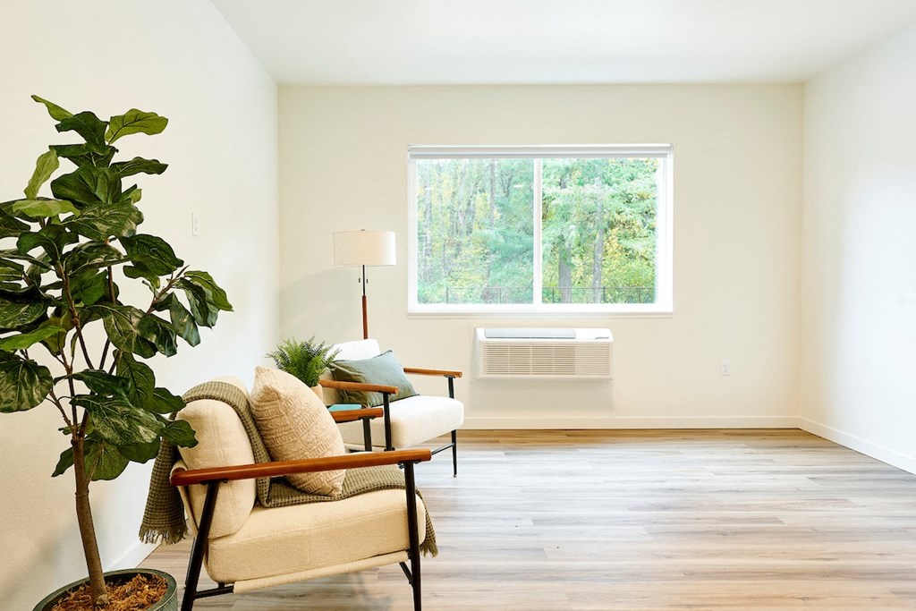 a living room with a chair and a window