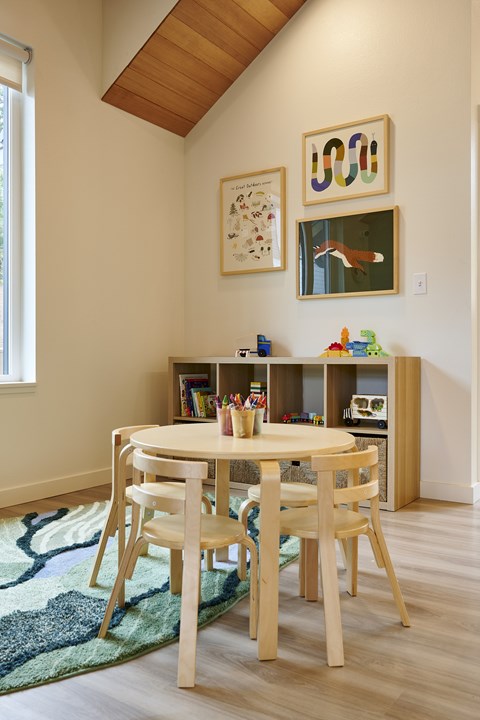 A dining room with a table and chairs.
