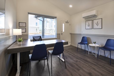 a dining room with a table and chairs and a window