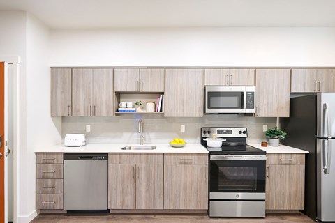 a kitchen with wooden cabinets and stainless steel appliances