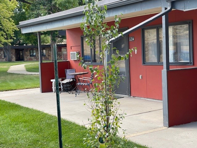A red building with a white door and windows.