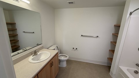 A bathroom with a sink, toilet, and stairs.