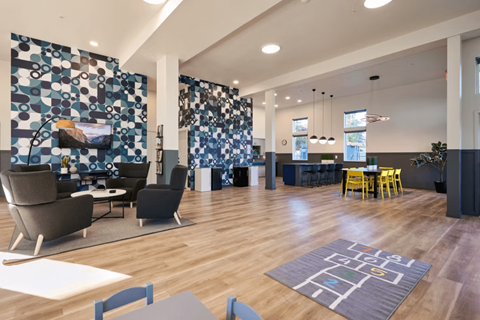 A modern living room with a blue and white patterned wallpaper.