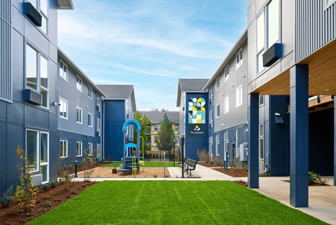 A playground area is located between two buildings.