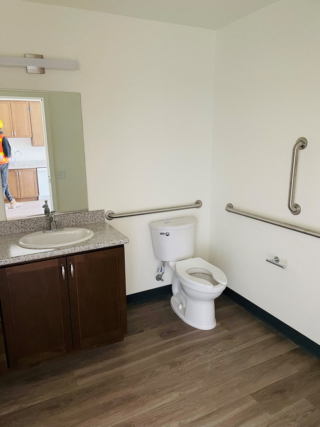 a bathroom with a toilet sink and mirror