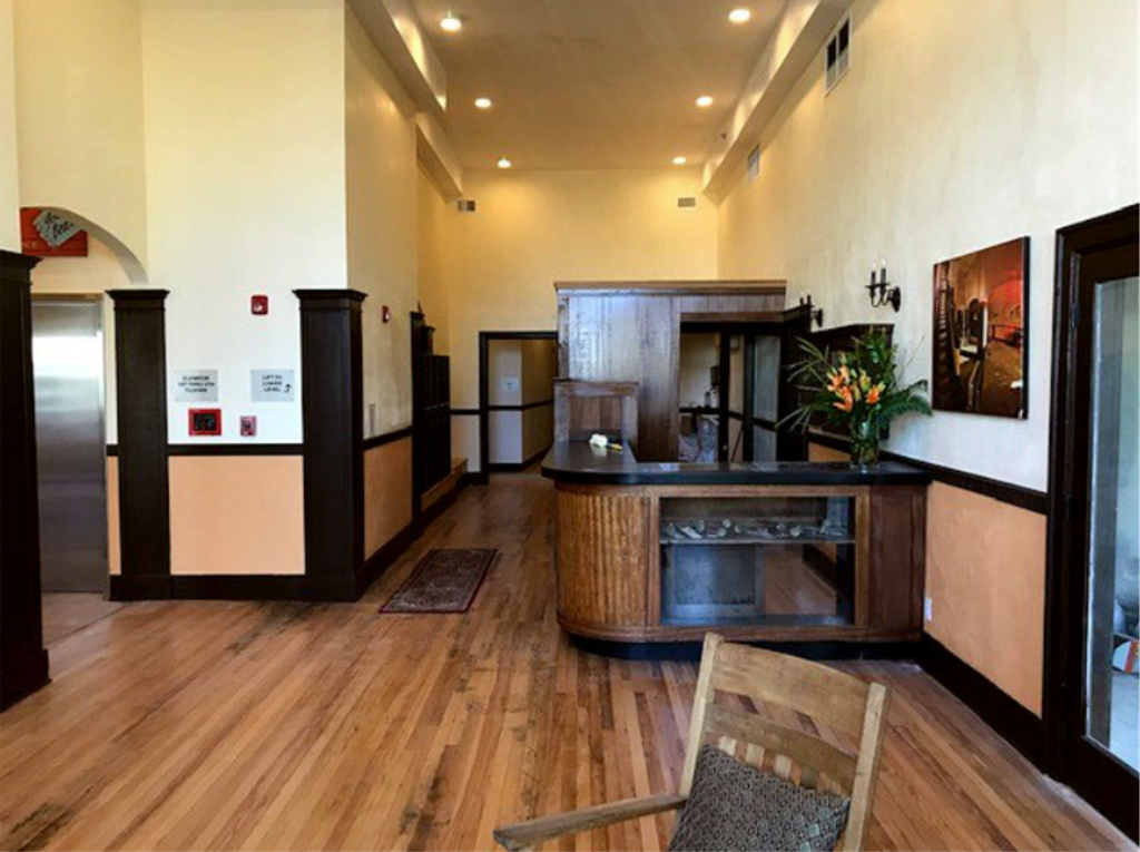 A wooden chair is in front of a wooden table.