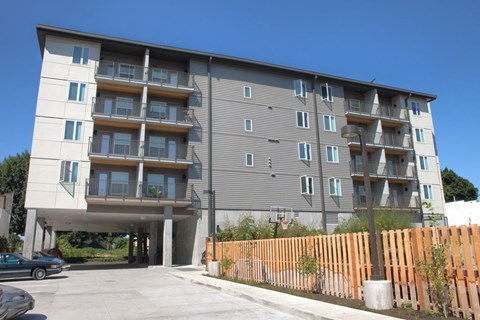 an apartment building with an overpass in front of it