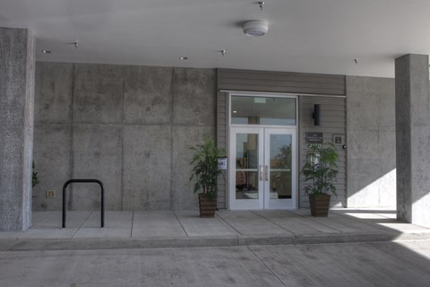 the front entrance of a building with a glass door