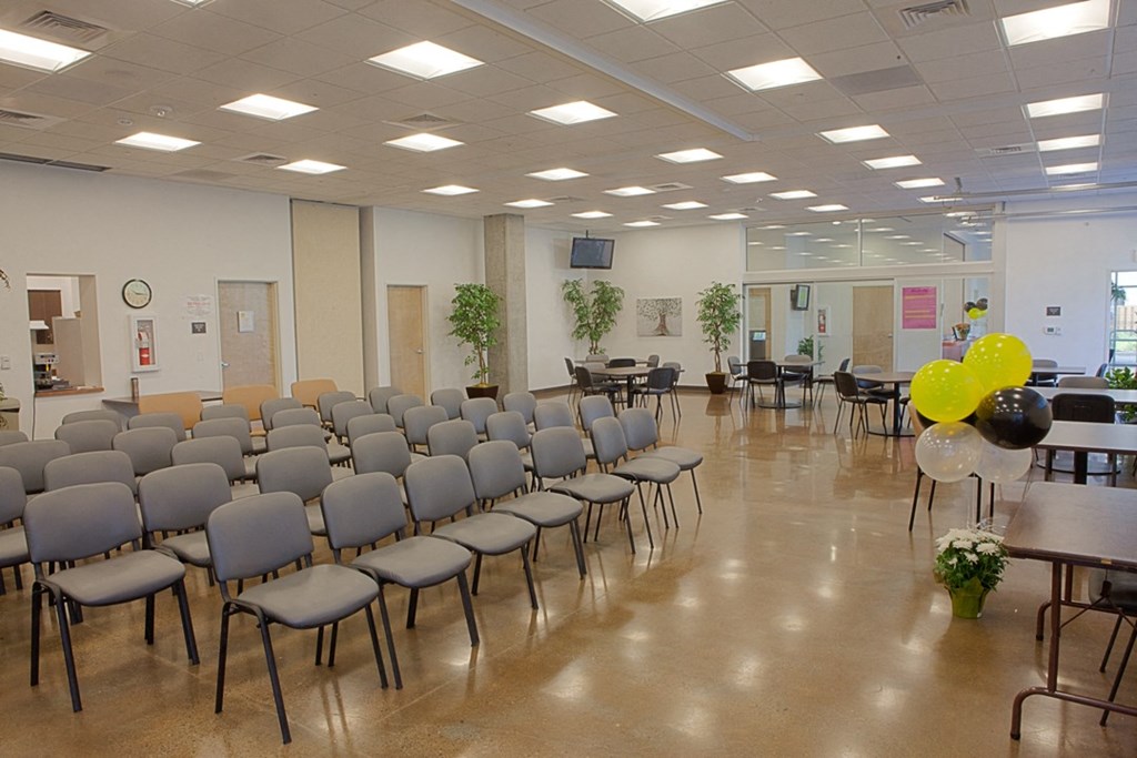 a multipurpose room with chairs and tables
