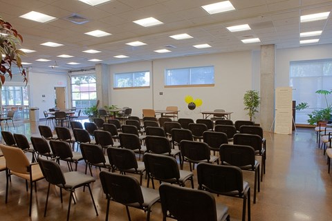 a large room filled with chairs and tables in a classroom