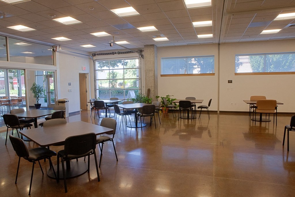 a dining room with tables and chairs in a hall
