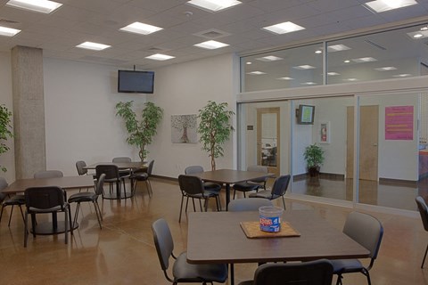 a dining room with tables and chairs and a television