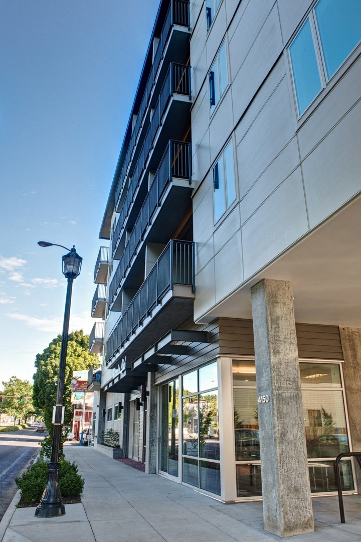 a city street with a building and a lamp post