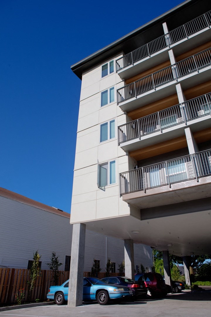 a tall building with cars parked in front of it