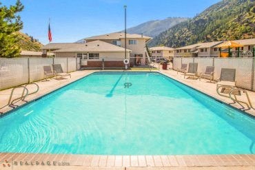 A large swimming pool with a mountain in the background.