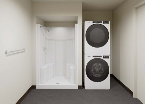 A white washing machine is in a small laundry room.