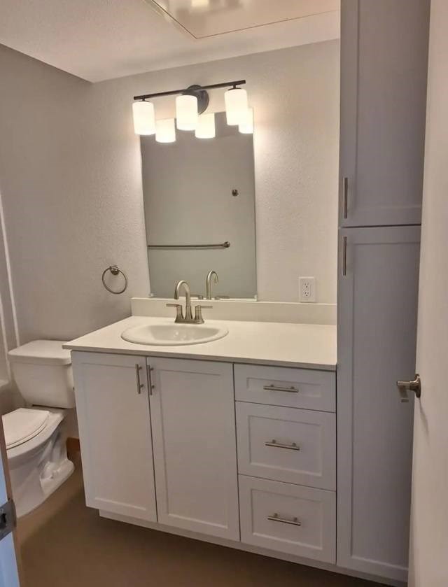 A bathroom with a white sink and a mirror above it.