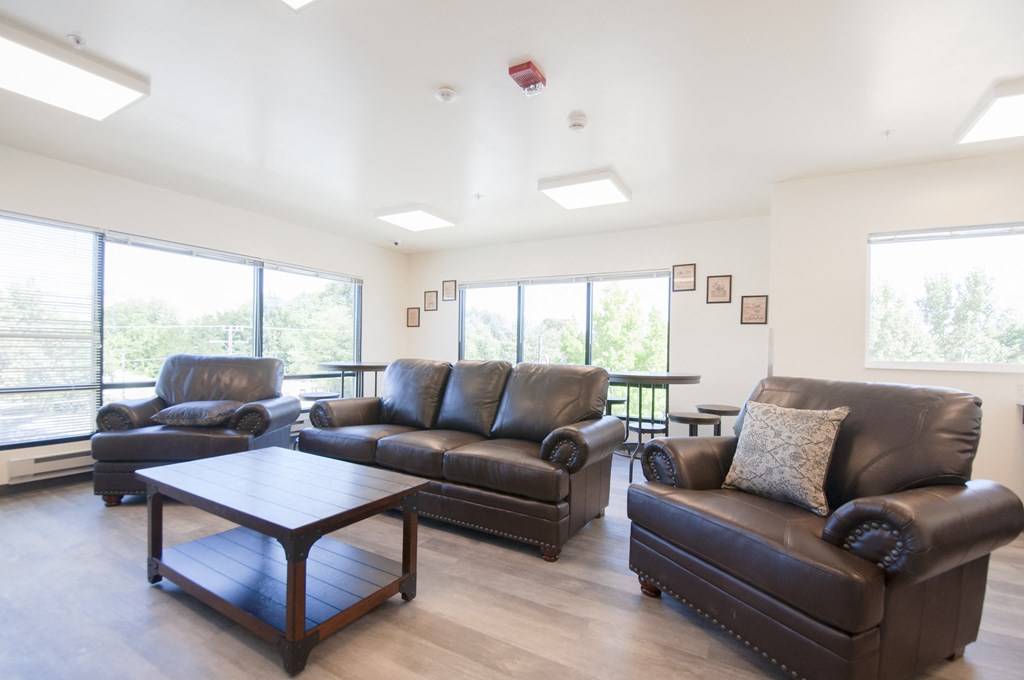 a living room with leather couches and a coffee table