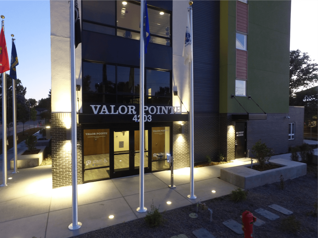 the facade of the valor pointe building at night