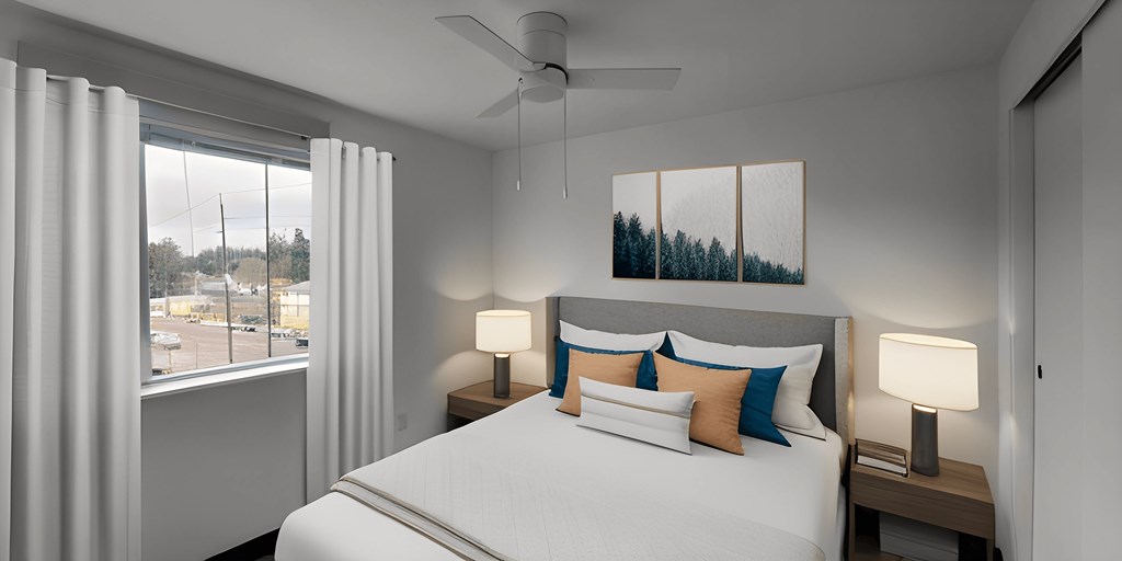 a bedroom with a large bed and a ceiling fan