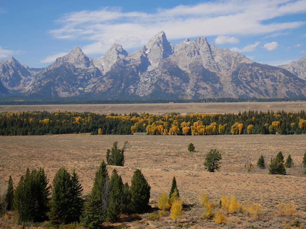 a view of the grand teton mountains and the snake river valley