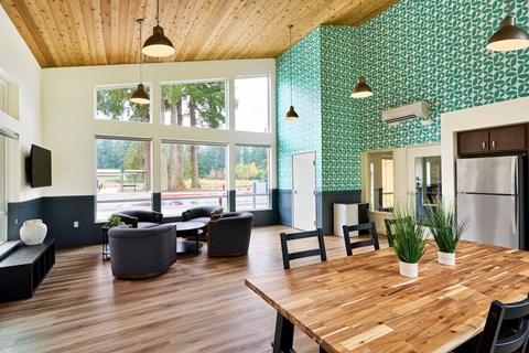 a large living room with a wooden table and chairs