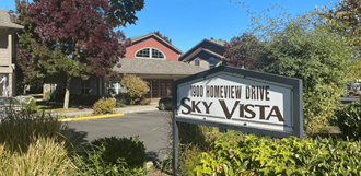 a photo of the sky vista sign in front of the building
