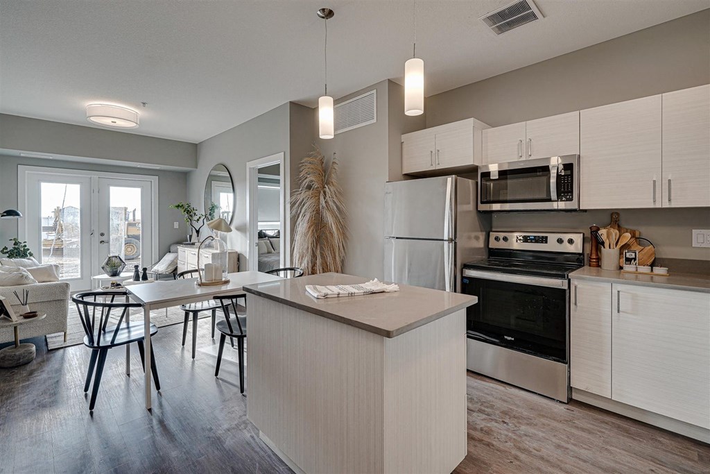an open kitchen and dining room with an island and a table