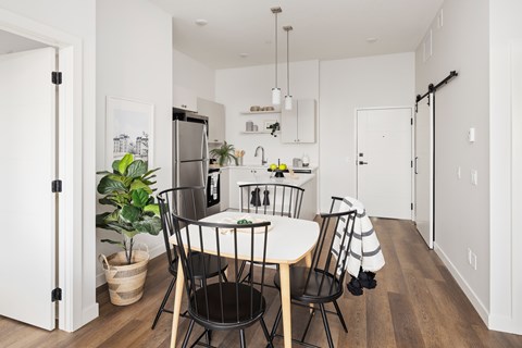 A kitchen with a table and chairs in the middle of the room.