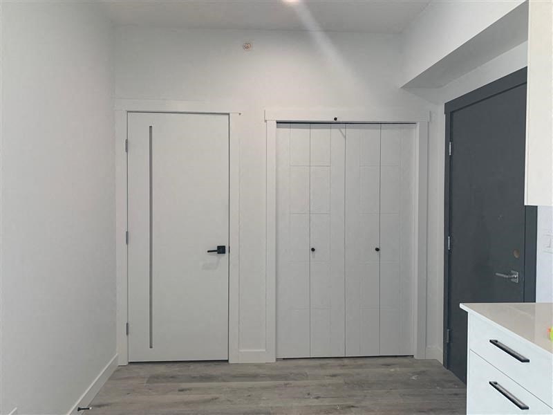 a white kitchen with white cabinets and white doors