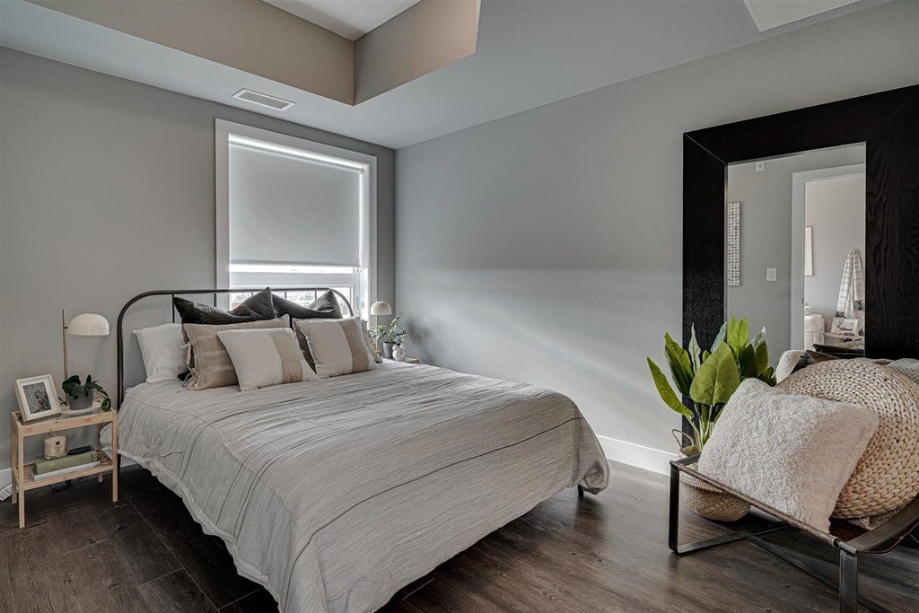 a bedroom with a bed and a large mirror