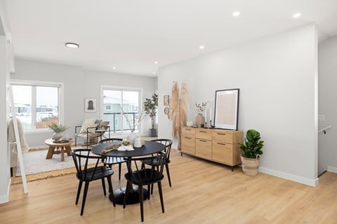 A dining room with a table and chairs.